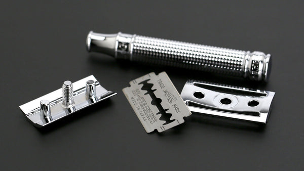 A disassembled safety razor and a double-edged razor blade