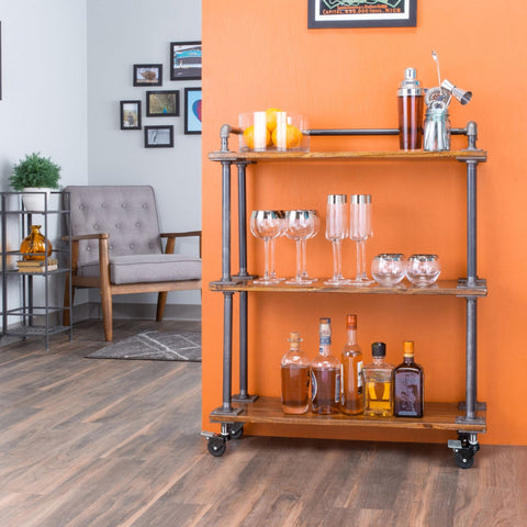 Image of a stylish PIPE DECOR® bar cart in a vibrant living space, showcasing glassware and spirits, ideal for entertaining or a chic home addition.