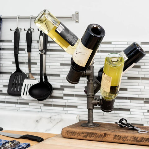 Image of a unique PIPE DECOR® wine holder displaying three bottles, a stylish and practical addition to any kitchen counter.