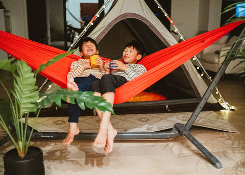 two boys sitting in hammock hung on Swiftlet portable hammock stand