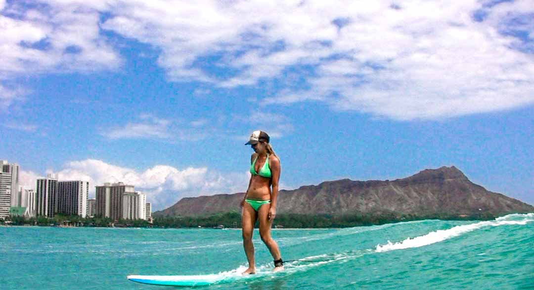 Artist Heather Brown surfing Waikiki waves