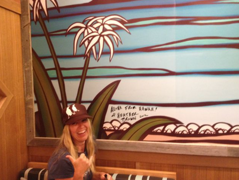 heather brown in front of her art at kailua weekend restaurant in shibuya, tokyo, japan