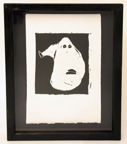 Abstract linocut print by heather brown showing black fish print on white paper with black wood frame