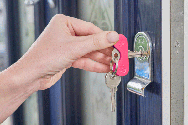 The pink Keywing in use on a front door.