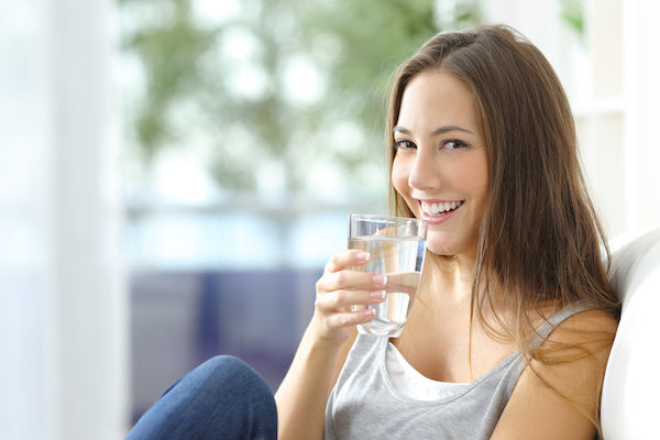 Happy Woman Drinking Filtered Water