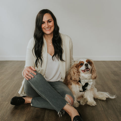 Wag & Wonder founder Karissa sitting on floor with Henry the Cavalier King Charles Spaniel