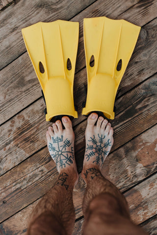 double foot tattoo with dive fins