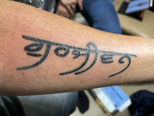 foreign language inner forearm tattoo