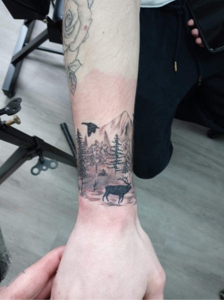 mountain wilderness forearm tattoo design