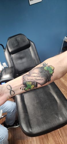 shamrock family forearm tattoo