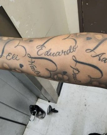 person's name tattooed on woman's arm