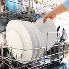 Loading dishwasher to save water.