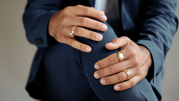 george rings man in suit wearing crown ring and hugo signet