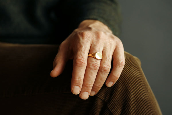 Man wearing Hugo Signet ring cast in solid 18k gold by George Rings