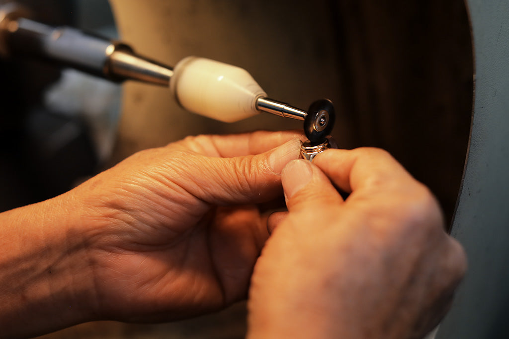 polishing button grande ring at george rings studio lost wax casting