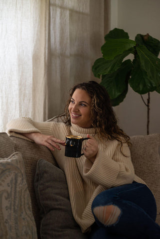 Woman holding black boobie mug for Breast Cancer Awareness