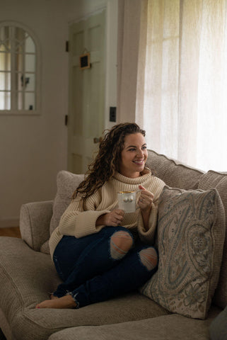 Woman holding white boobie mug for Breast Cancer Awareness