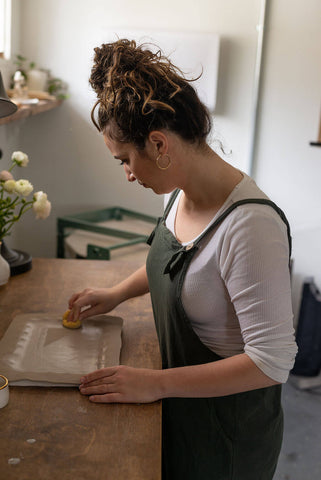 Woman working with ceramic pottery before putting it into the kiln