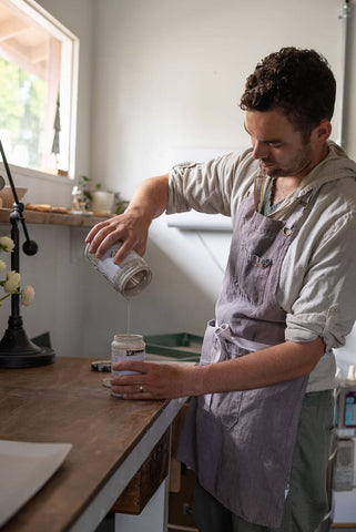 Man mixing ceramic pottery glaze in pottery studio