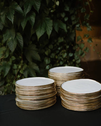 white homemade pottery dinnerware with gold overglaze