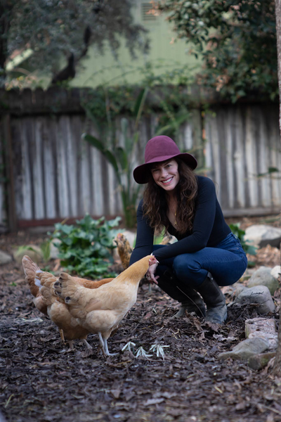 Emily Hirsch on the farm with chickens.