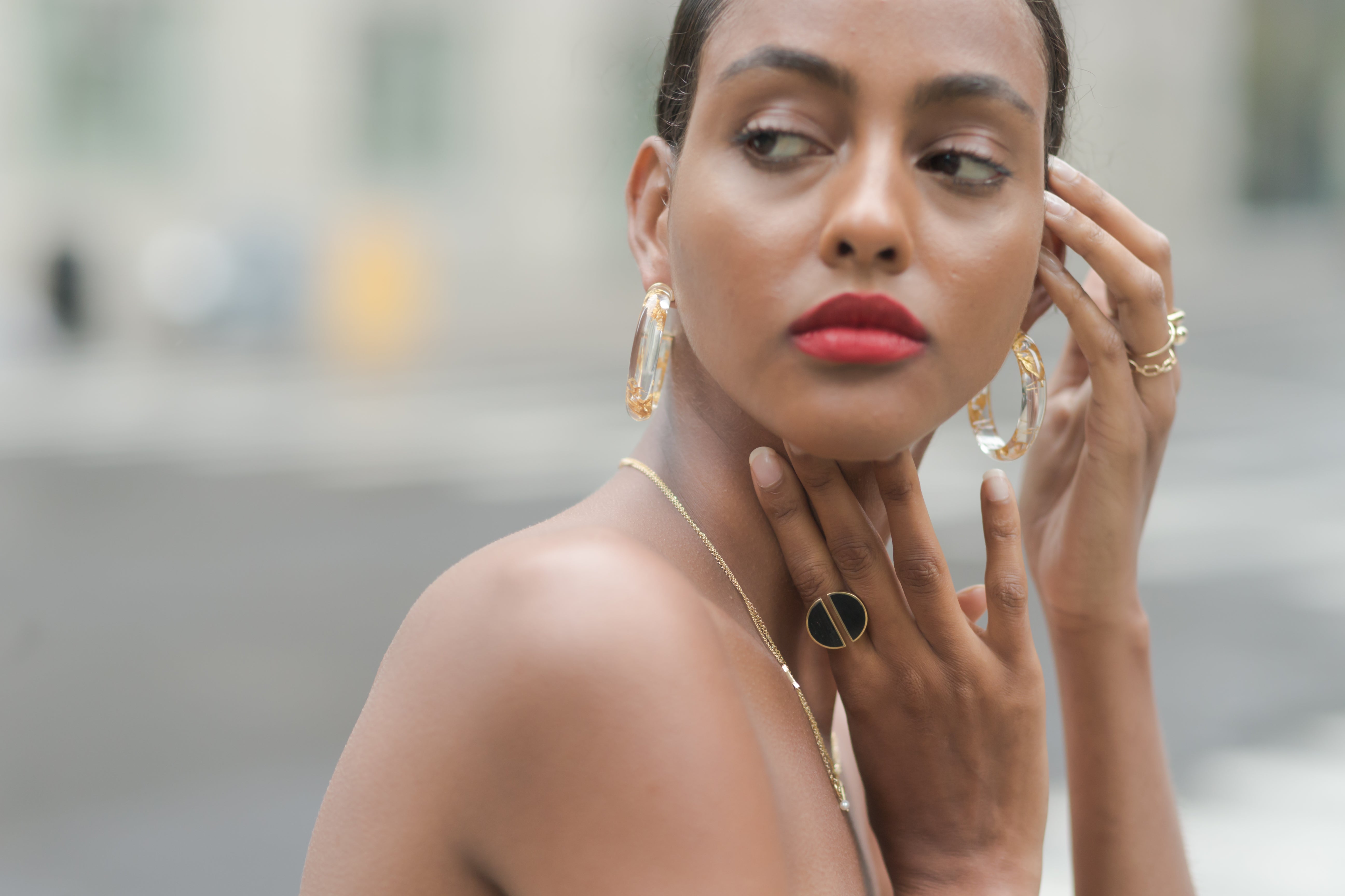 Model wearing big hoops earrings