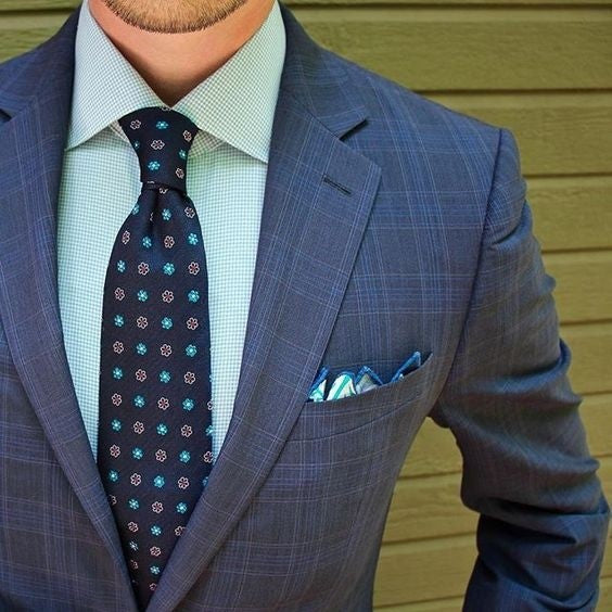 blue shirt and navy suit