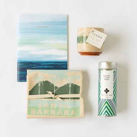 Notebook, candle, tea and kitchen towel flat lay