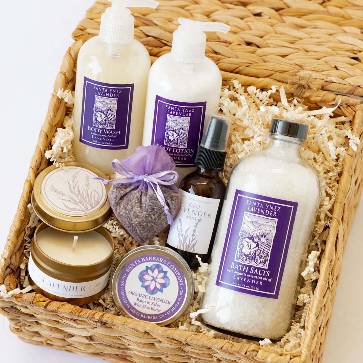 Woven gift basket filled with lavender bath products and a candle