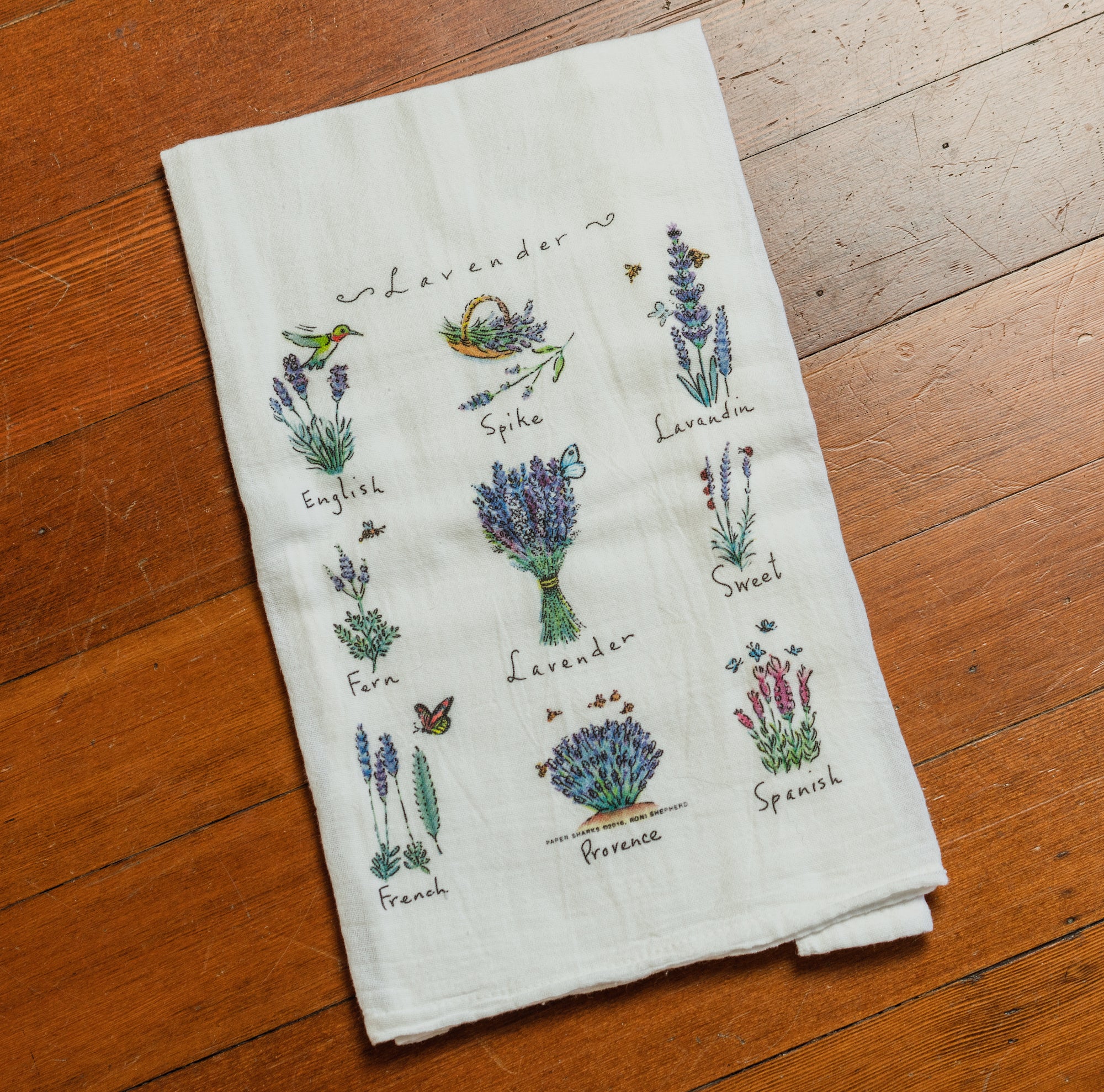 White towel with illustrations of 9 different types of lavender