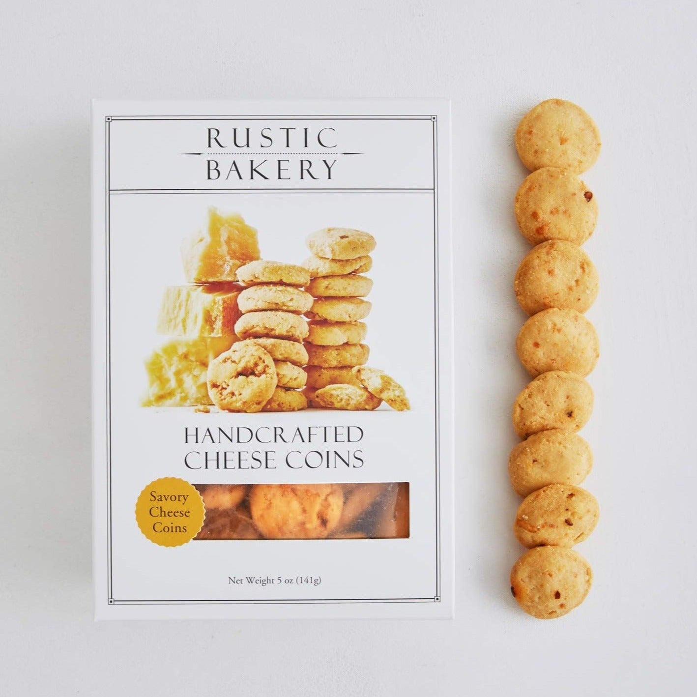 A box with a picture of small round yellow cheese bites and a row of them lined up next to the box
