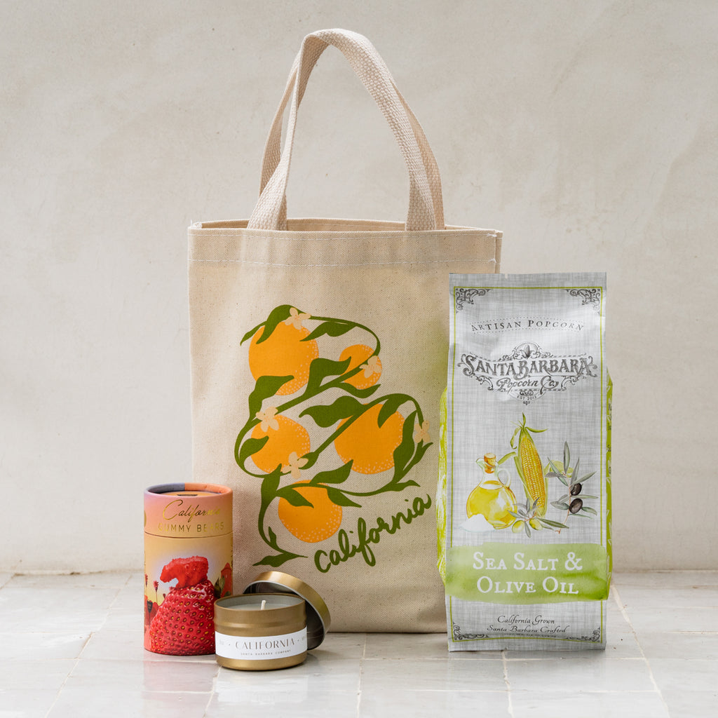 Golden State Citrus Gift Tote featuring gummy bears, popcorn and a candle.