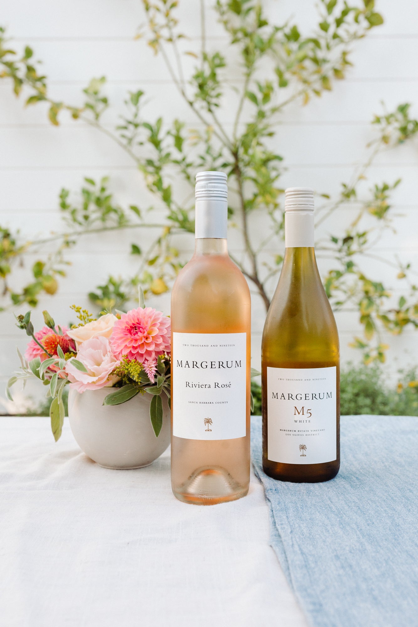 Margerum M5 white & riviera rose wines next to springtime flowers