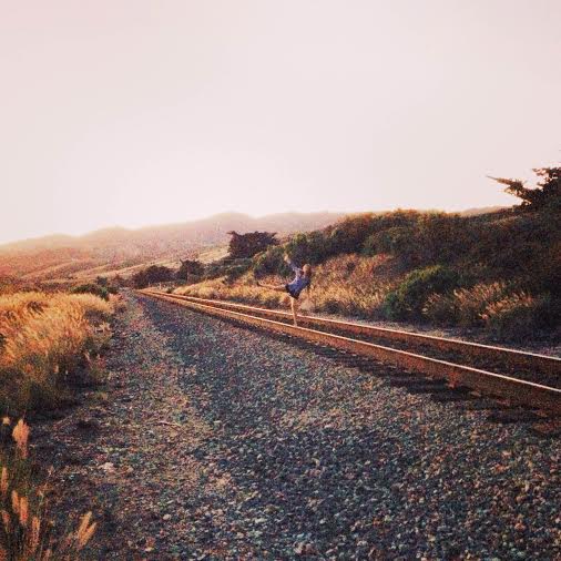 woman on train tracks at tajiguas beach california
