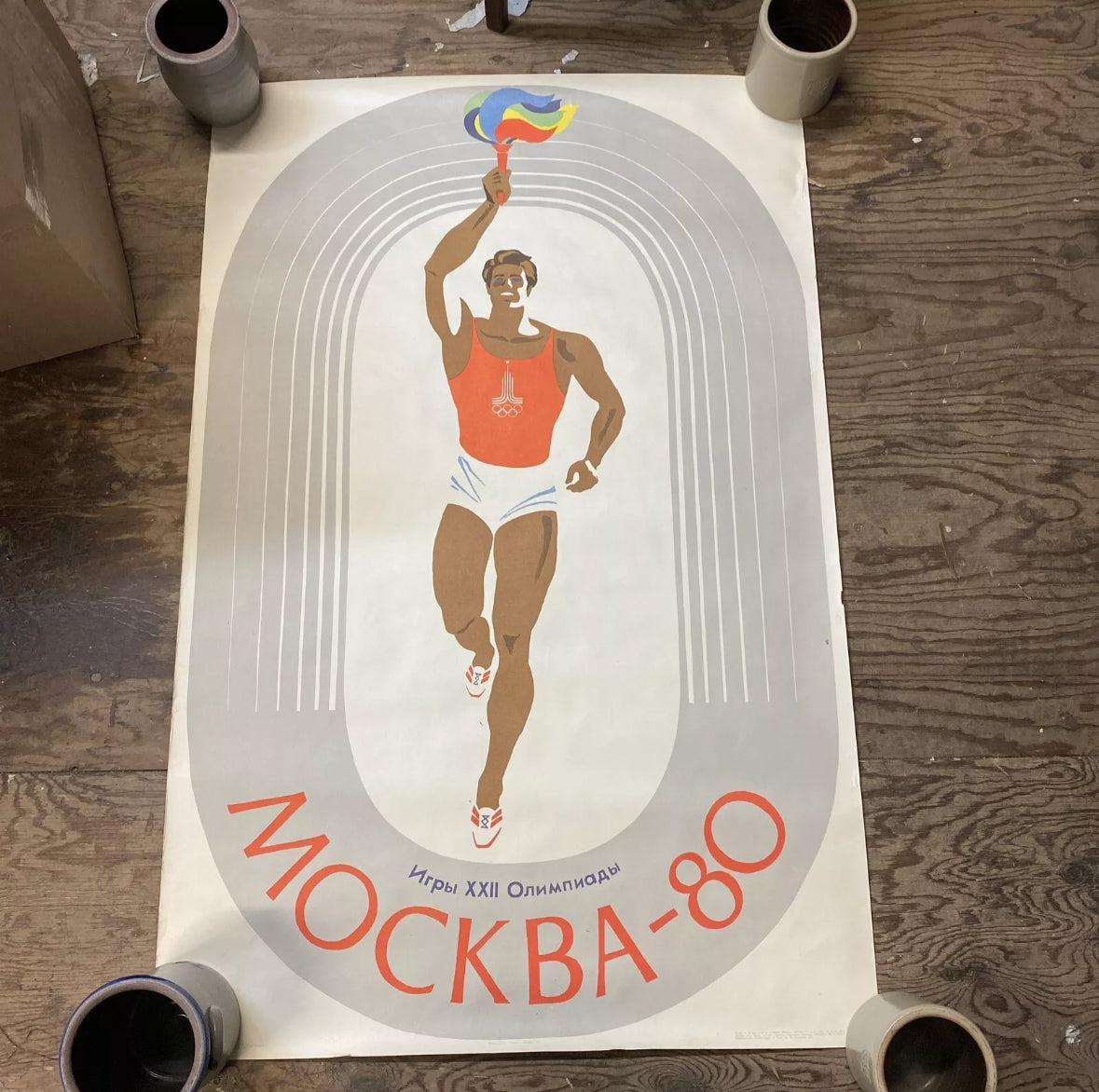 "Moscow-80 - Games of the 22nd Olympic Games" - Soviet Russian poster (1979) by V. Zhabsky. Shows a running man, Olympic symbols, and a smiling face in red and white colors.