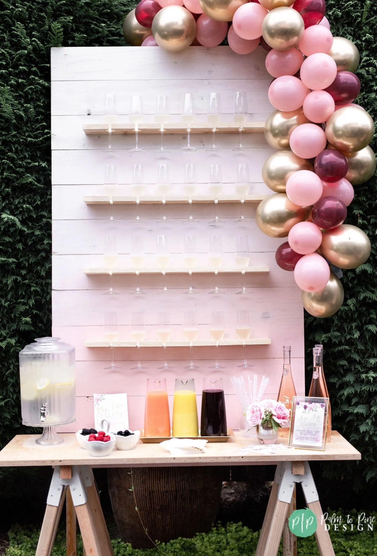 champagne wall and pink balloon garland