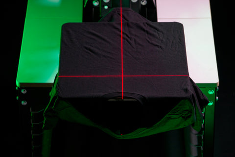 a black t-shirt with a red laser producing a T on it