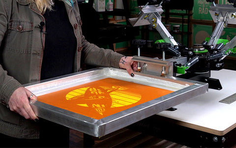 person holding a screen on press