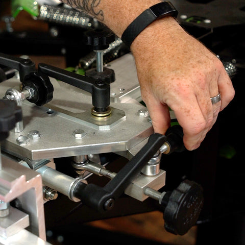 hand adjusting a micro on a riley hopkins press