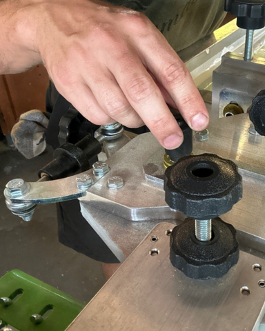 a hand tightening a micro registration knob on a riley hopkins 300 press
