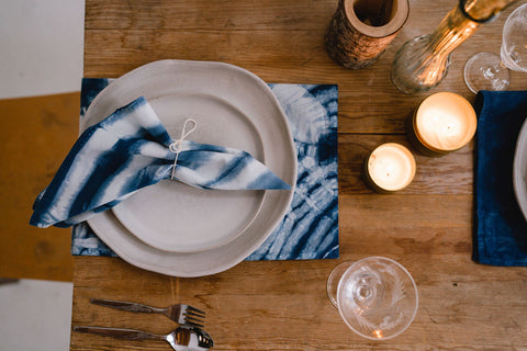 table set with indigo napkins and candles