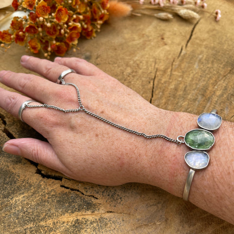Handchain worn with 2 rings and cuff bracelet made with kyanite and moonstone