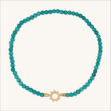 Gold petite nine-pointed star adorned by turquoise beads