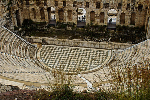 A weathered ancient Roman colosseum with checkered floor