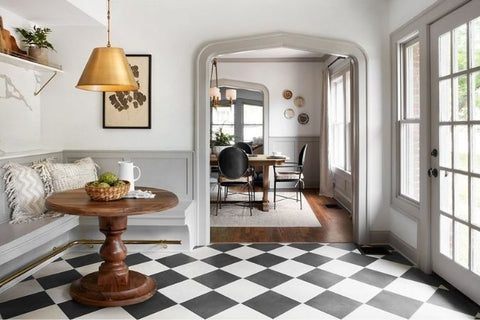 Seating area with French Doorsl, wood table, and black and white checkered floor