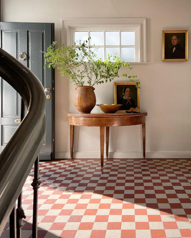 Red and white checkered tile floor in a European cottage home entry way