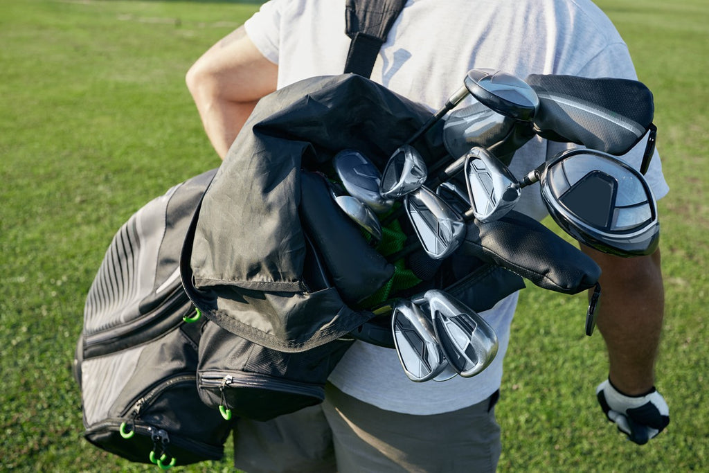 golfer-carrying-bag-of-golf-clubs