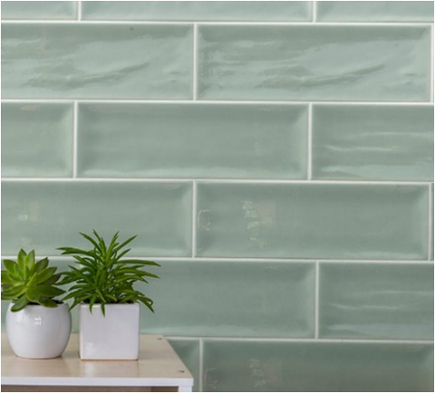 10x30cm Aria Green Brick tile wall with green succulent plants on wood effect table