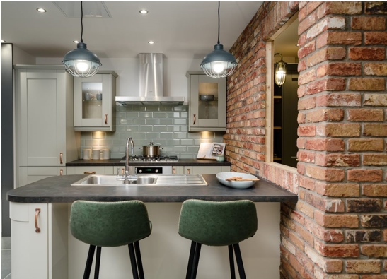 light sage kitchen cabinets with sage tile splashback and bare-brick wall effect tiles