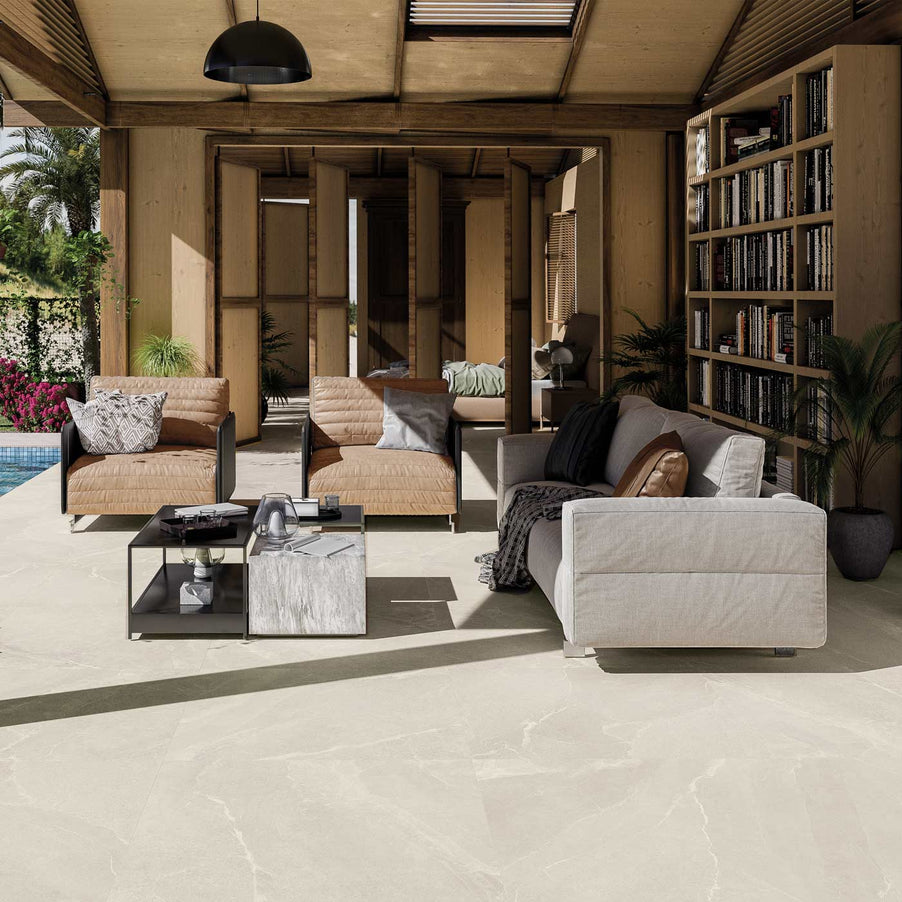 100x100cm Marseille White tile in an indoor outdoor setting, hacienda style. with lounging area and bookcases